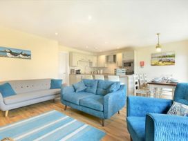 A living room with seating and dining area at Beach Walk in Chathill