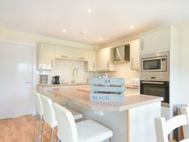 A kitchen with cabinets and appliances at Beach Walk in Chathill