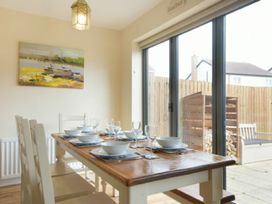 A dining room with a table set for dinner at Beach Walk in Chathill