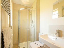 A bathroom with shower and sink at Beach Walk in Chathill