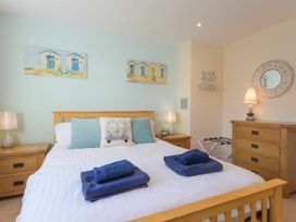 A bedroom with a bed and nightstand at Beach Walk in Chathill
