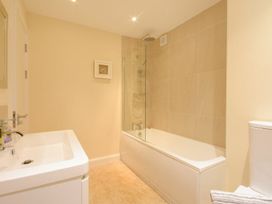 A bathroom with a bathtub and shower at Beach Walk in Chathill