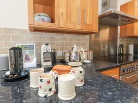 A kitchen with a kettle and coffee machine at Woodbine Cottage in Weymouth
