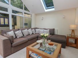 A snug with a sofa and coffee table at Woodbine Cottage in Weymouth
