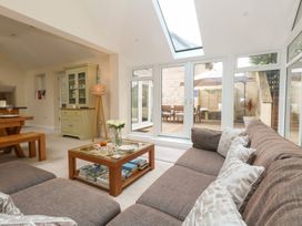 A living room with a sofa and coffee table at Woodbine Cottage in Weymouth