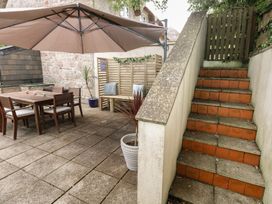 An outdoor area with a dining table and chairs at Woodbine Cottage in Weymouth