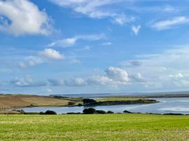 A view of hills and water at Woodbine Cottage in Osmington