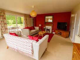 A living room with a sofa and television at Campden in Rennington near Embleton