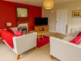 A living room with sofas and a television at Campden in Rennington near Embleton