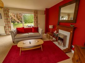 A living room with a sofa and coffee table at Campden in Rennington near Embleton