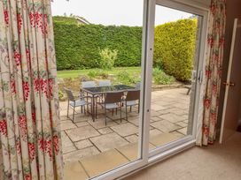View of a patio with table and chairs from an indoor area at Campden in Rennington near Embleton