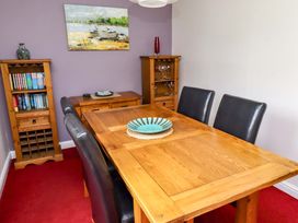 A dining room with a wooden table and chairs at Campden in Rennington near Embleton