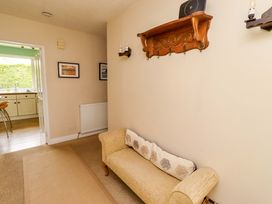 A hallway with a sofa and framed pictures at Campden in Rennington near Embleton