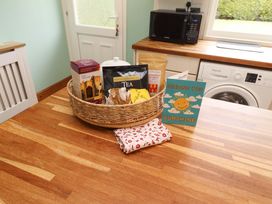A kitchen countertop with a basket containing tea and chocolate at Campden in Rennington near Embleton