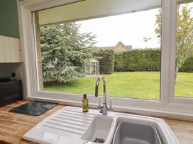 A kitchen with a sink and view of a garden at Campden Rennington near Embleton