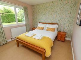 A bedroom with a bed and bedside table at Campden in Rennington near Embleton