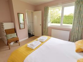 A bedroom with a bed and wardrobe at Campden in Rennington near Embleton