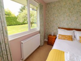 A bedroom with a bed and bedside table at Campden in Rennington near Embleton