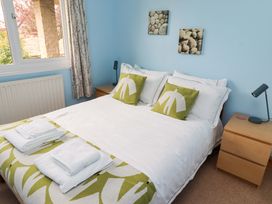 A bedroom with a bed and bedside table at Campden in Rennington near Embleton