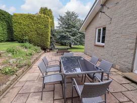 An outdoor patio with table and chairs at Campden in Rennington near Embleton