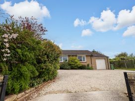 A house with a garage and driveway at Campden in Rennington near Embleton