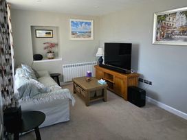 A living room with a sofa and television at Pant in Holyhead