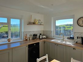 A kitchen with windows and appliances at Pant in Holyhead