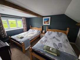 A bedroom with two beds and a window at Pant in Llanfaethlu near Holyhead