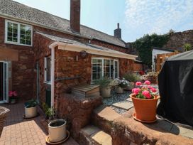An outdoor area with flower pots and paving stones at Pete's Place in Taunton