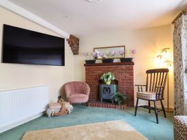 A living room with a television and fireplace at Pete's Place in Taunton