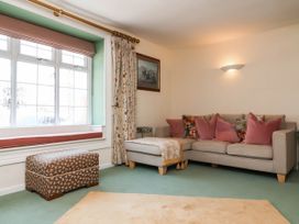 A living room with a sofa and cushions at Pete's Place in Taunton