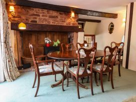 A dining room with a table and chairs at Pete's Place in Taunton