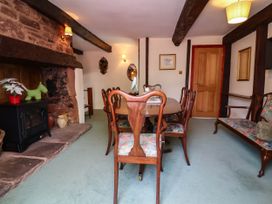 A dining room with a table and chairs at Pete's Place in Taunton