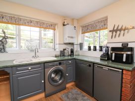 A kitchen with appliances and windows at Pete's Place in Taunton