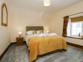 A bedroom with a bed and nightstand at Pete's Place in Taunton