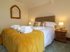 A bedroom with a bed and nightstand at Pete's Place in Taunton