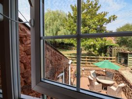 A view of a garden with chairs and a table from a window at Pete's Place in Taunton