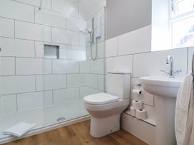A bathroom with a shower, toilet, and sink at Pete's Place in Taunton
