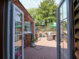 An outdoor patio area with a table and chairs at Pete's Place in Taunton