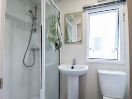 A bathroom with a shower, sink, and toilet at Forest Retreat - FO26 in Saxmundham