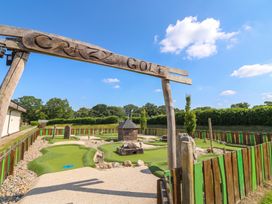 A crazy golf course with a sign in an outdoor setting at Forest Retreat - FO26 in Saxmundham