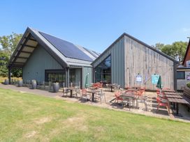 An outdoor area with tables and chairs at Forest Retreat - FO26 Saxmundham