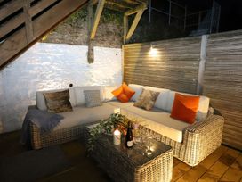 A seating area with a sofa and table in an outdoor space at Dart Views in Dartmouth