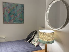 A bedroom with a bed and decorative lamp at Dart Views in Dartmouth