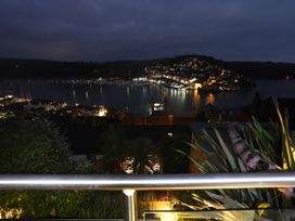 A view of a town by the water at night at Dart Views in Dartmouth