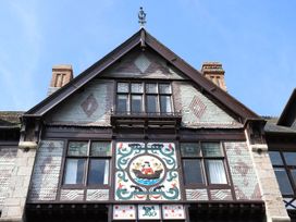 Building facade with decorative panel and windows at Dart Views in Dartmouth