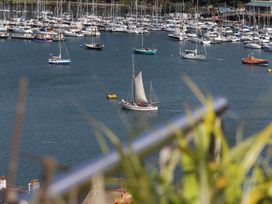 A marina with various boats and a sailboat on the water at Dart Views in Dartmouth