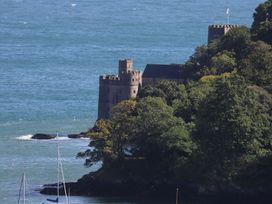 A castle near the ocean surrounded by trees at Dart Views in Dartmouth
