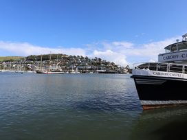 A boat in the water near buildings at Dart Views in Dartmouth