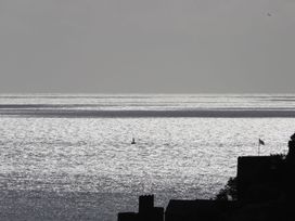 A view of the sea with a sailboat and buildings at Dart Views in Dartmouth